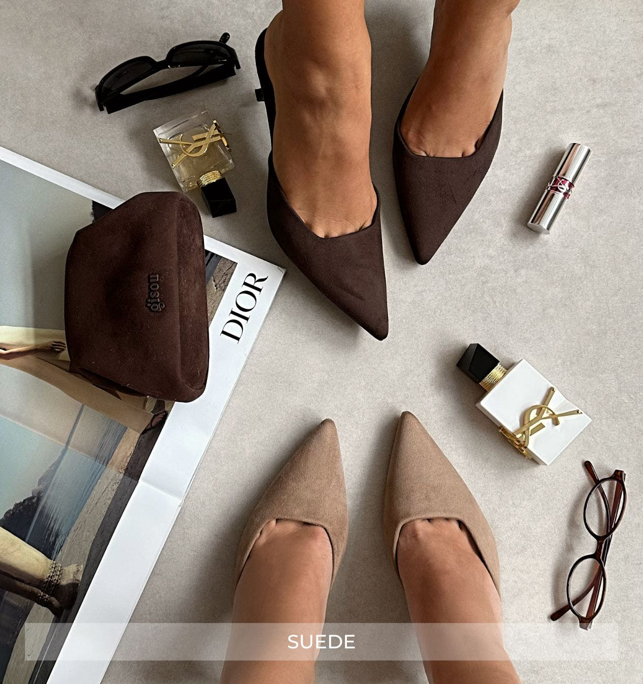 Brown suede shoes with accessories on a light surface