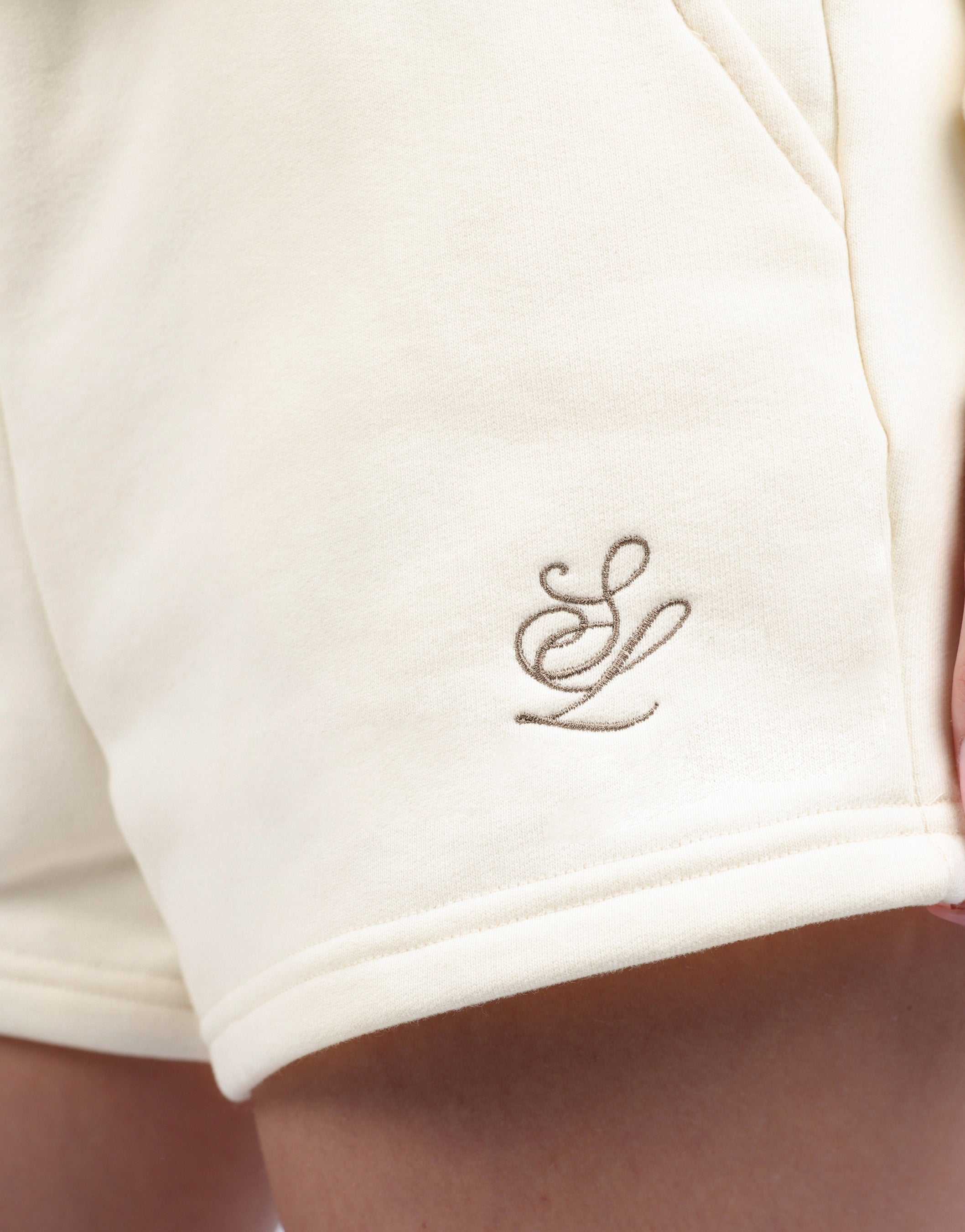 Riva Simmi Studios Embroidered Logo Shorts In Cream | Simmi London