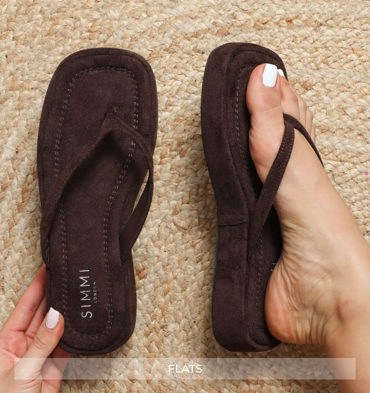 Brown flip-flops worn on a textured surface