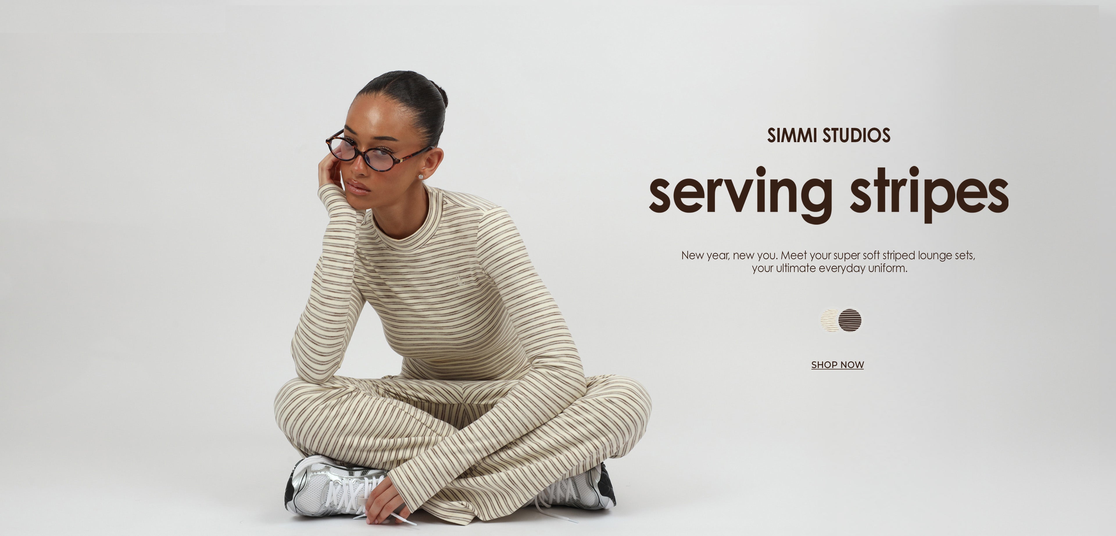 Person wearing a striped outfit with 'SIMMI STUDIOS serving stripes' text on a white background