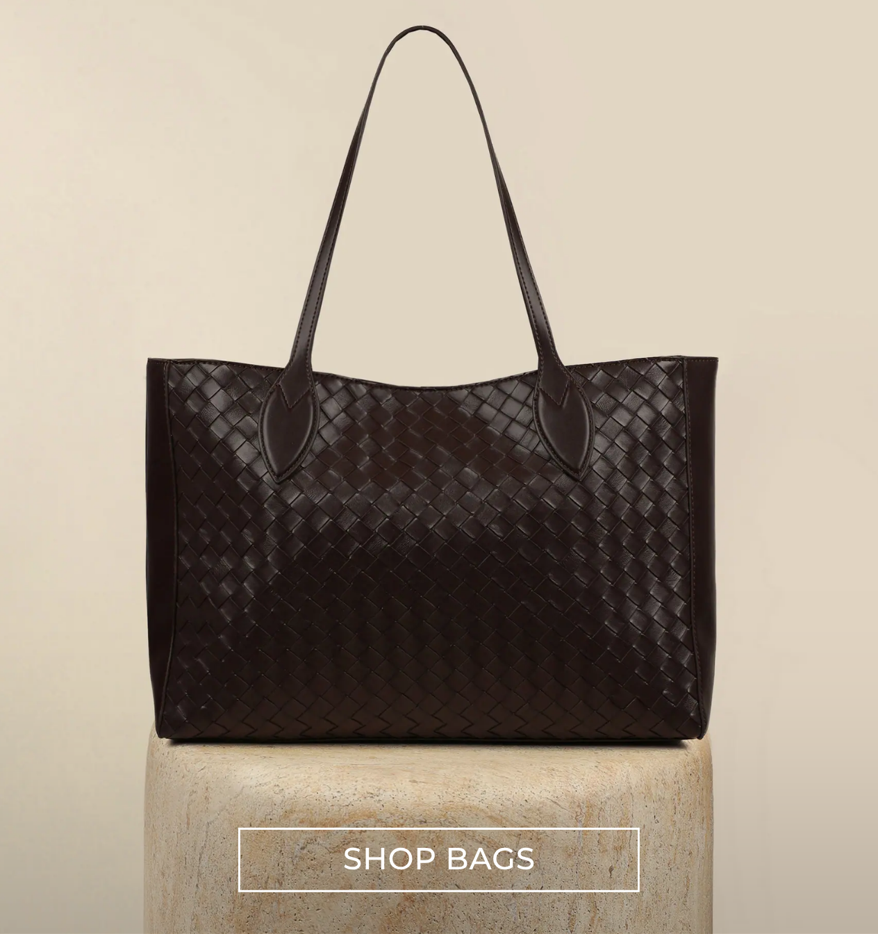 brown weaved brown bag on a cream back ground at simmi london