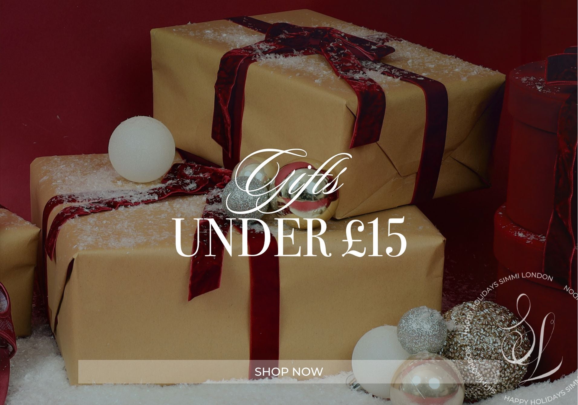 Gift boxes with ribbons and decorative balls on a red background, featuring text 'Gifts UNDER £15' and 'Shop Now'.