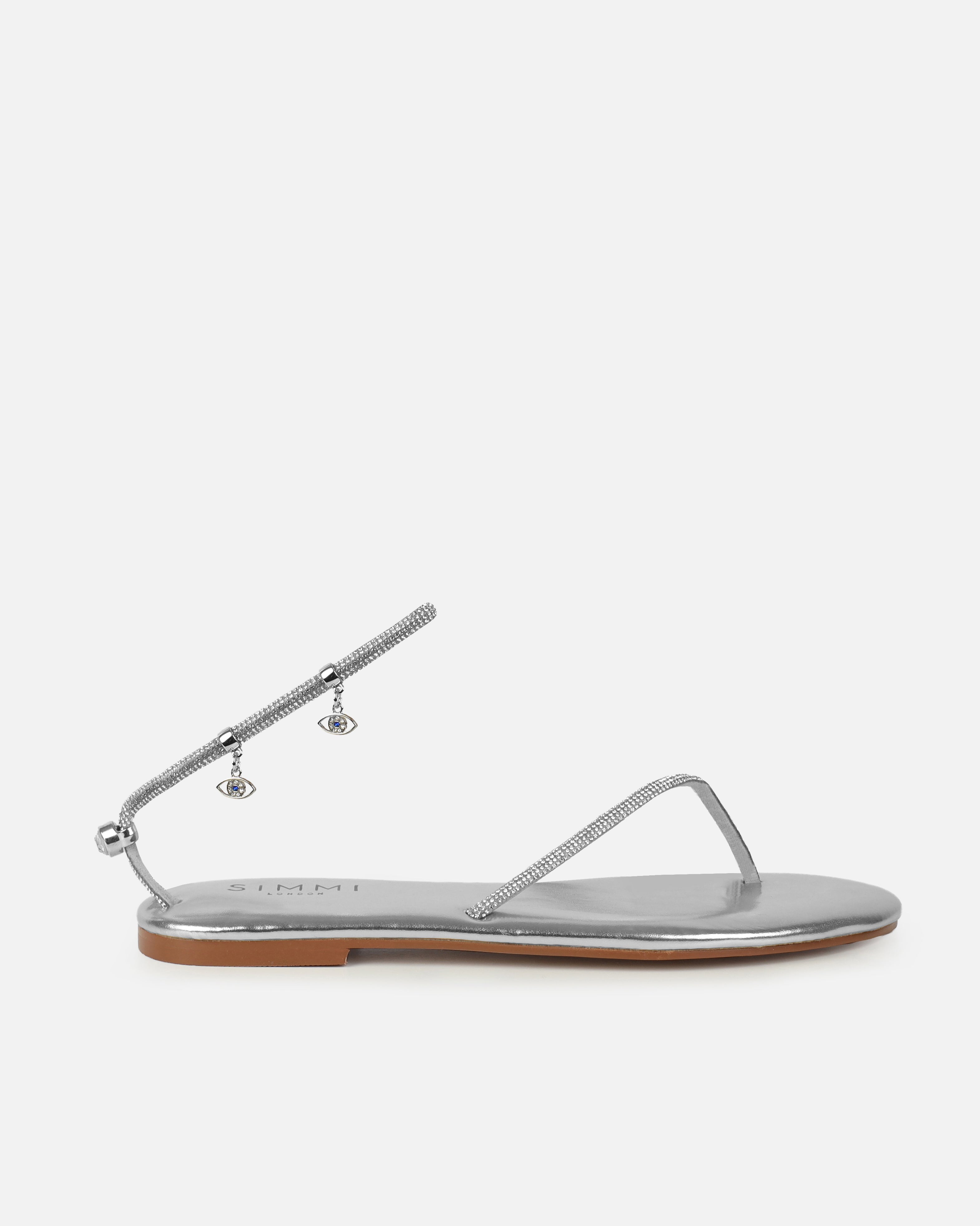 Dakoa Silver Metallic Evil Eye Charm Flat Sandals | SIMMI London
