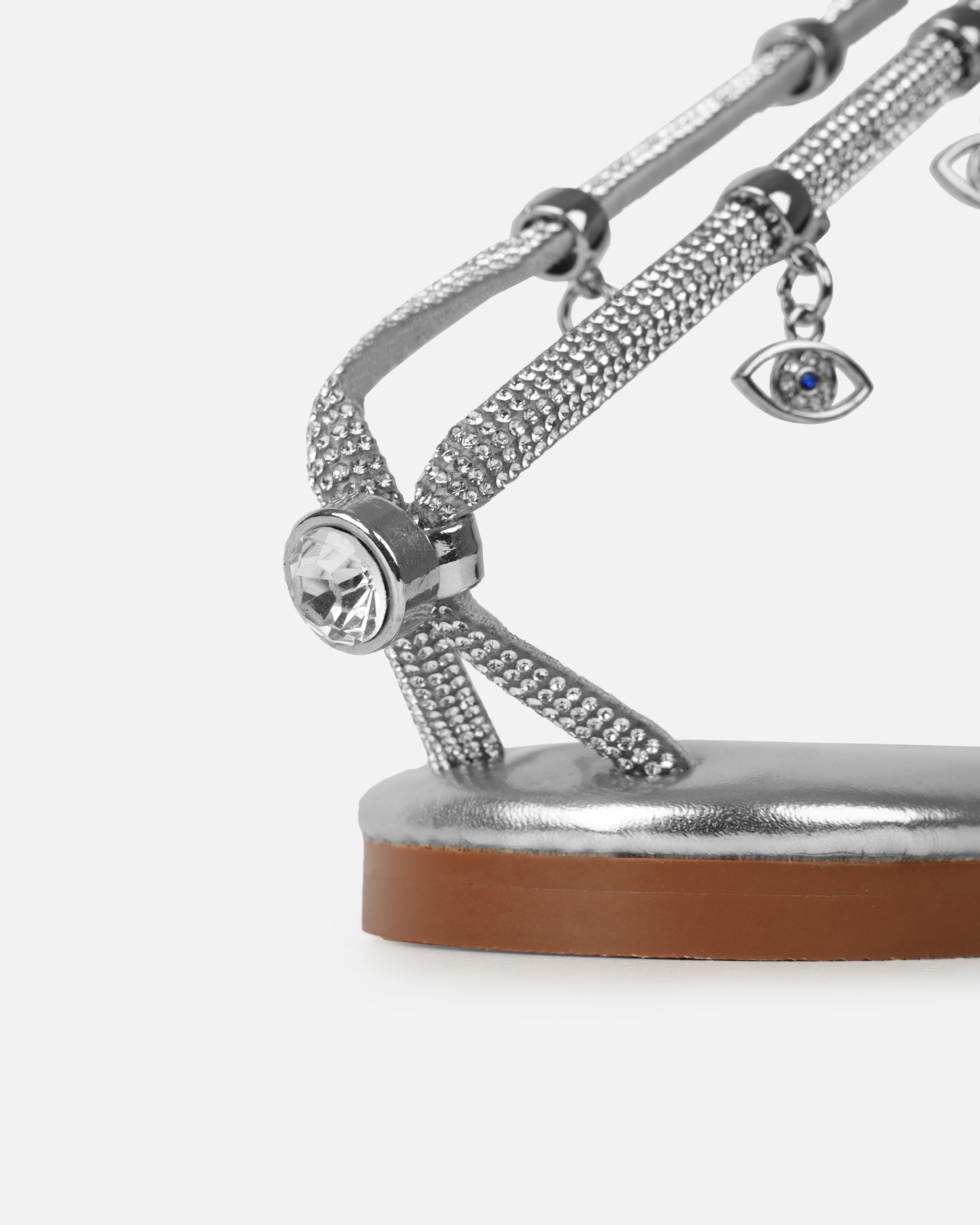 Dakoa Silver Metallic Evil Eye Charm Flat Sandals | SIMMI London